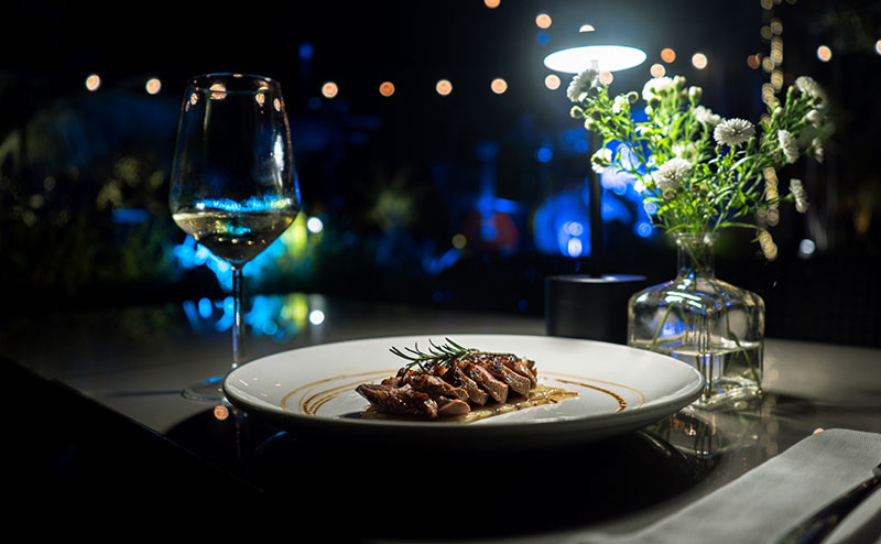 Closeup of a dining table with a plate of food