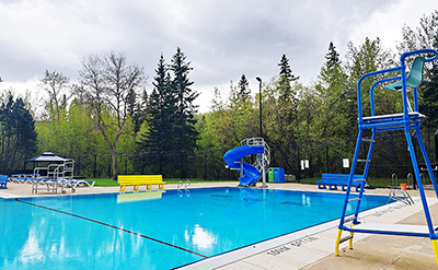 pool and deck with chairs