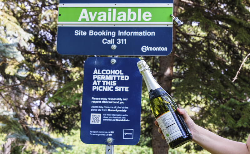 An "alcohol permitted" sign at a bookable picnic site
