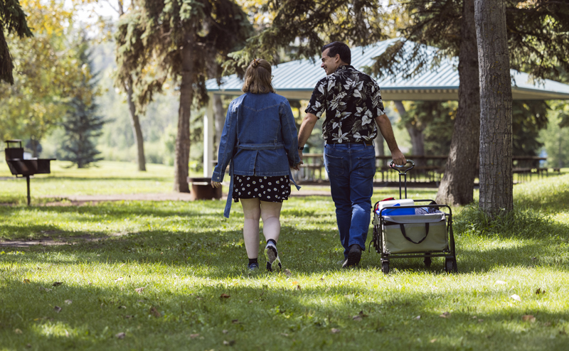 Two people with a wagon of items at Rundle picnic site #2