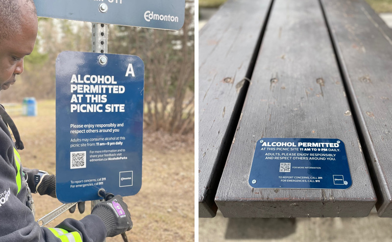 Photo of two types of signs indicating that alcohol is allowed at a picnic site. One sign is on a sign post, the other affixed to a picnic table.