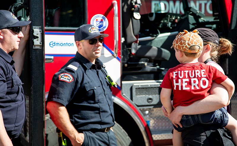 Firefighters talk with family