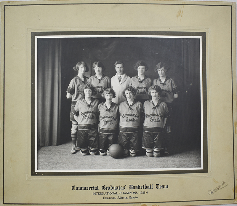Black and white photo of the Edmonton Grads. An inscription reads: "Commercial Graduates' Basketball Team International Champions, 1923-4 Edmonton, Alberta, Canada"