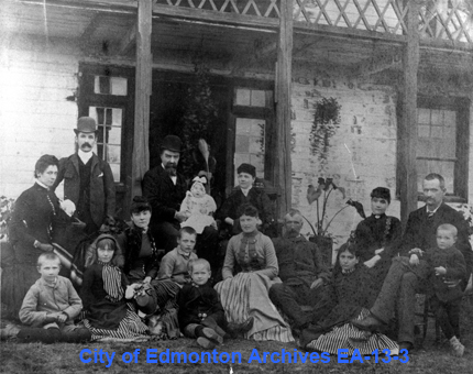 Three families in front of the Big House at Fort Edmonton in 1884.