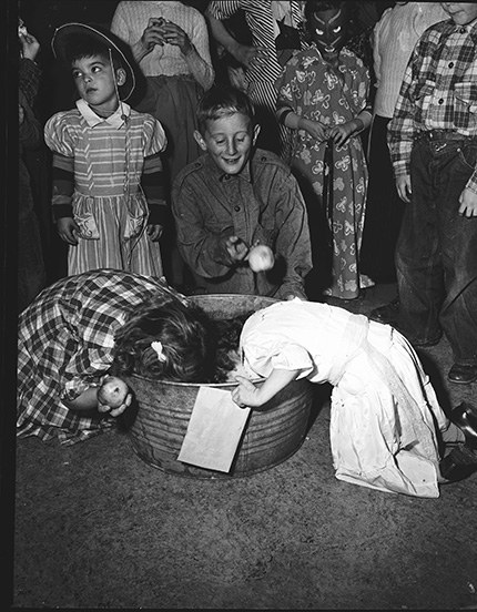 Children bobbing for apples.