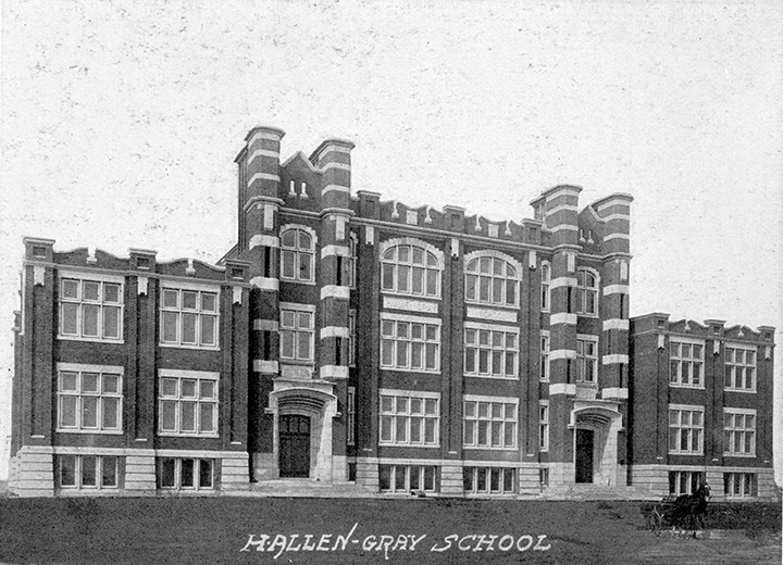 Black and white photo. A large multi-story school building with two entrances in front. Text overlaid at the bottom of the photo reads "H. Allen-Gray School".
