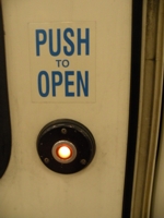 The door open button on an LRT train