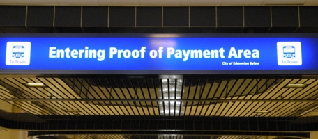 A blue sign indicating a Proof of Payment area