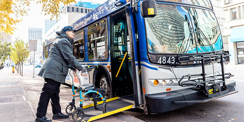 A passenger with a walker boarding a bus