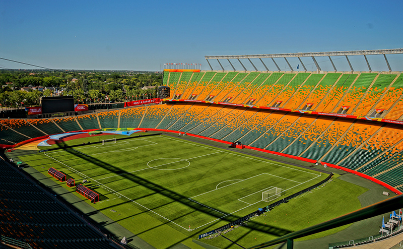 Colour aerial photo of Commonwealth Stadium during a clear day. The field is configured for soccer, with goals at either end.
