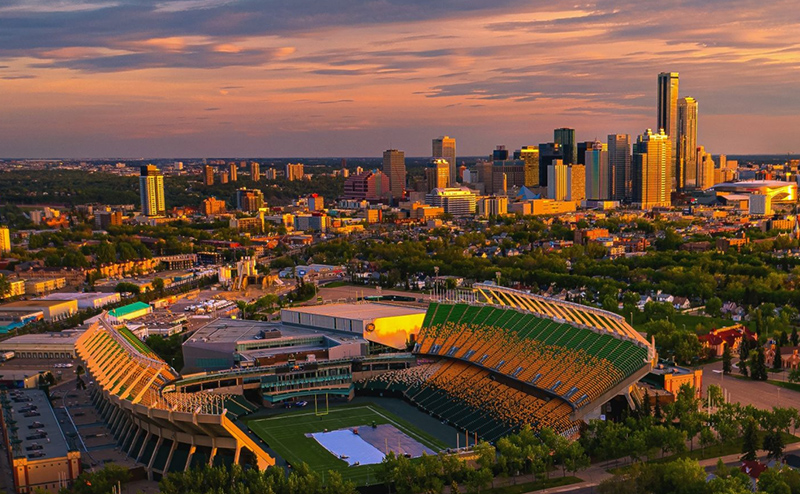 Colour aerial photo of Commonwealth Stadium during a cloudy sunset.