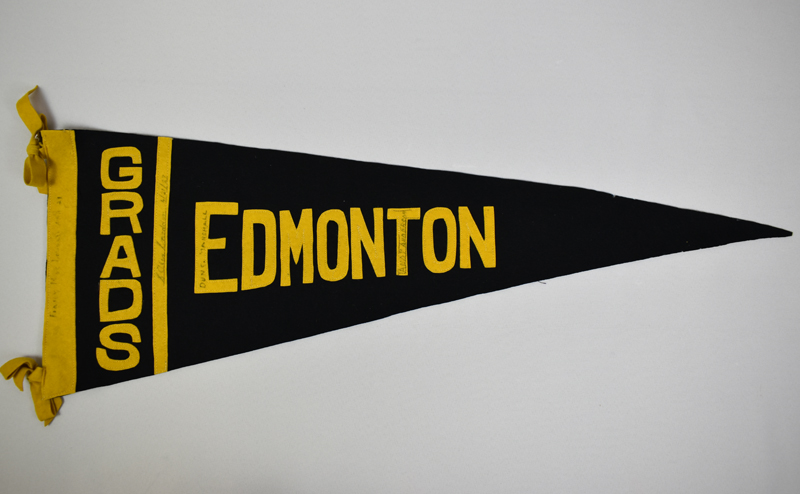 A black and yellow triangular flag that says "Grads Edmonton".