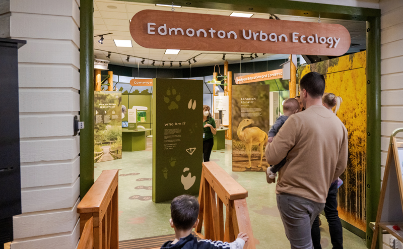 A family enters the Edmonton Urban Ecology area at JJNC.