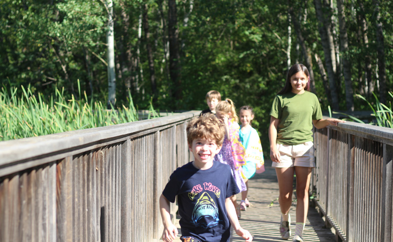 Kids walking across a bridge.