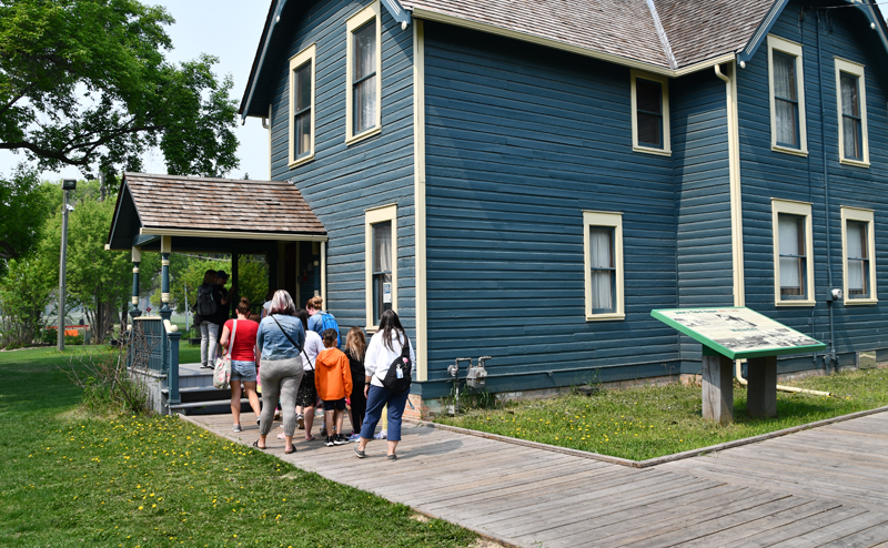 A tour group visiting a building at John Walter Museum.