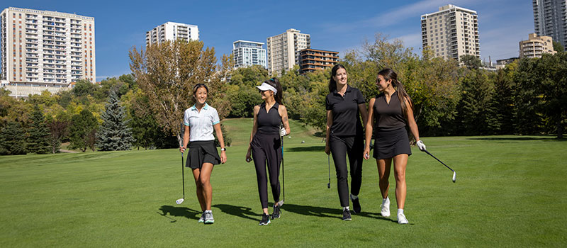 Four golfers walking the course