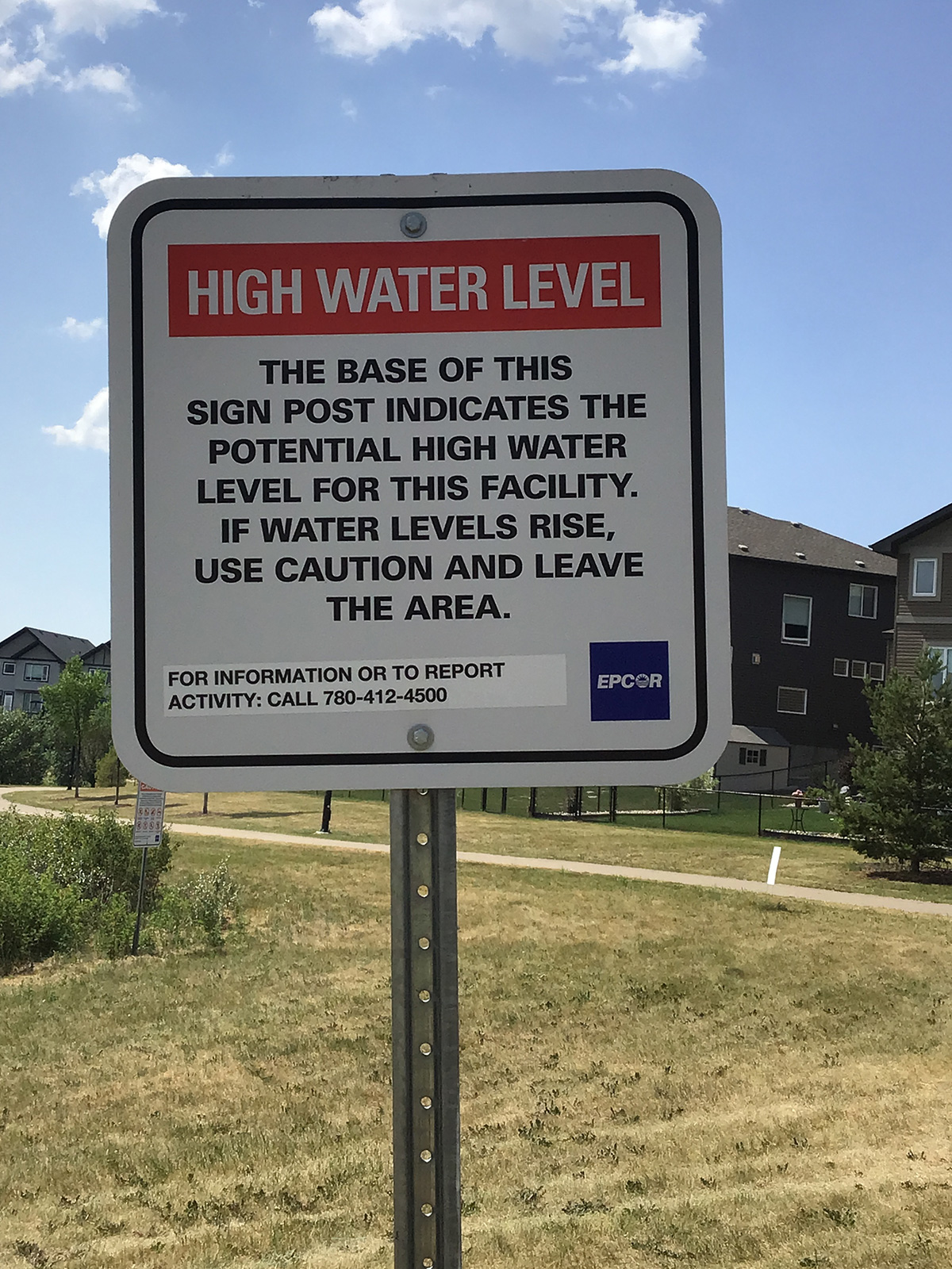 A sign at a stormwater facility indicating the high water line level
