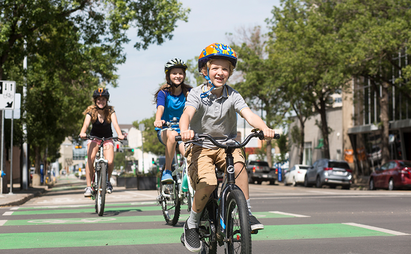 A family riding bikes in a bike lane