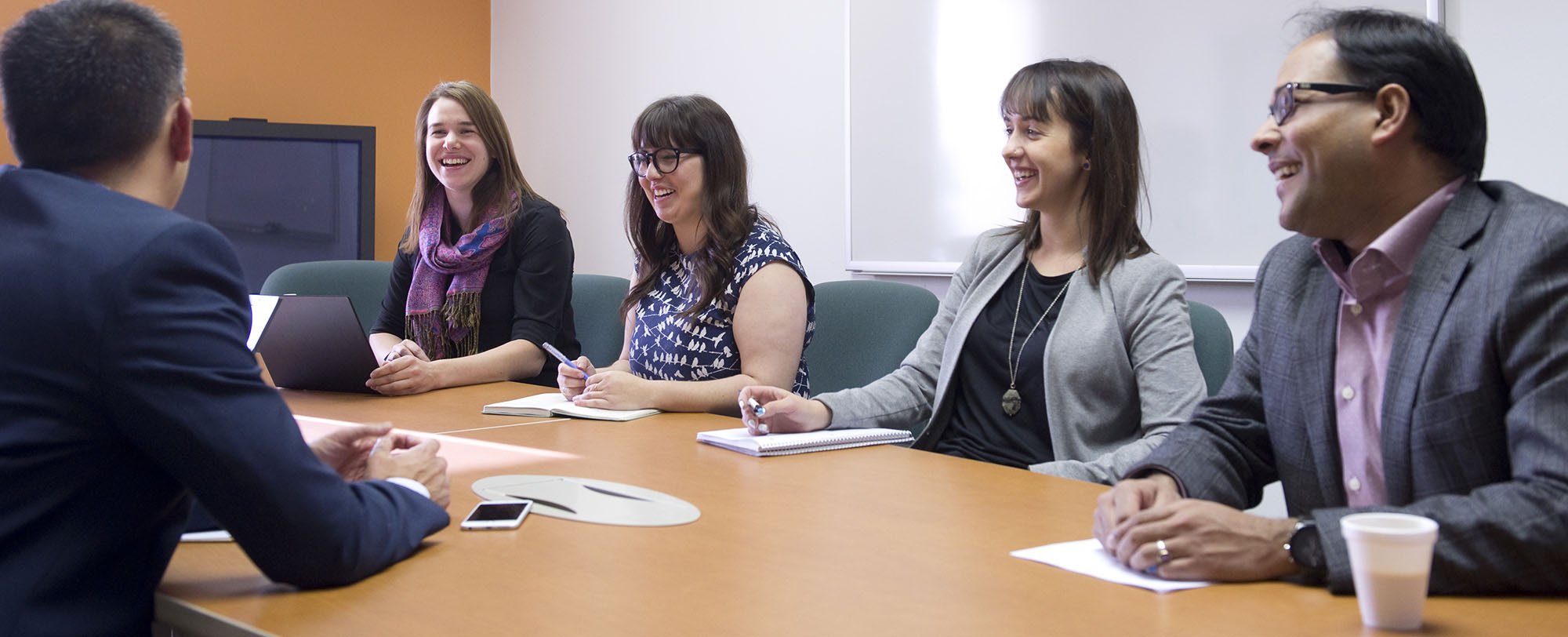 People gathered around a boardroom table