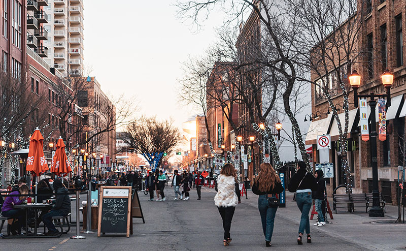 people walking down street in open market