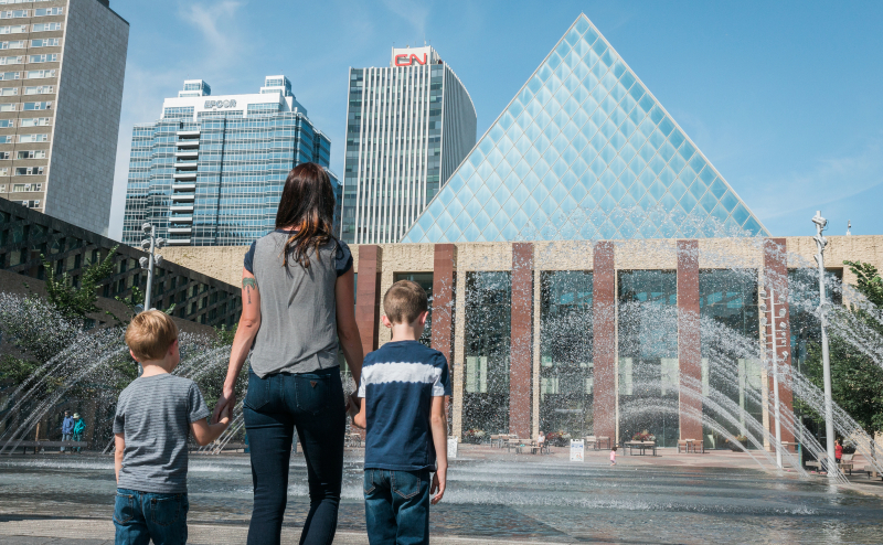 Parent and children standing in front of Edmonton City Hall