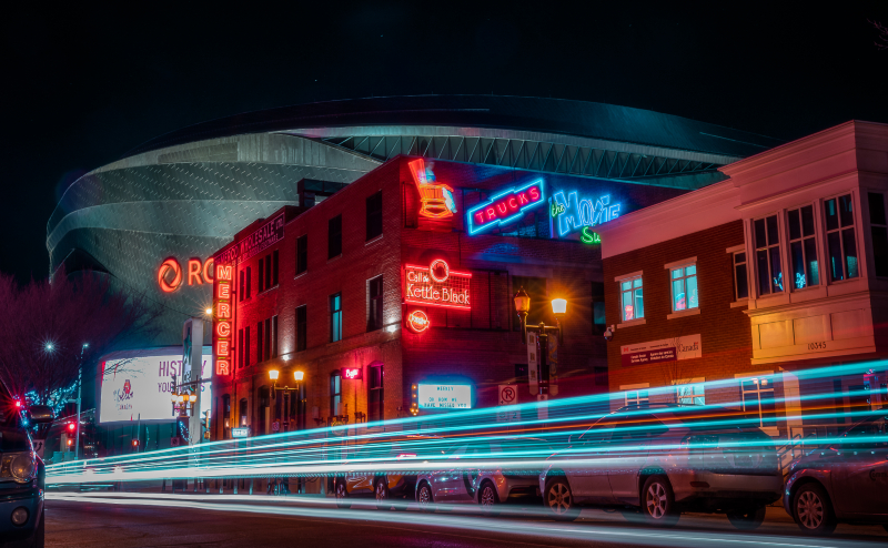 Light trails in front of Neon Sign Museum and Rogers Place