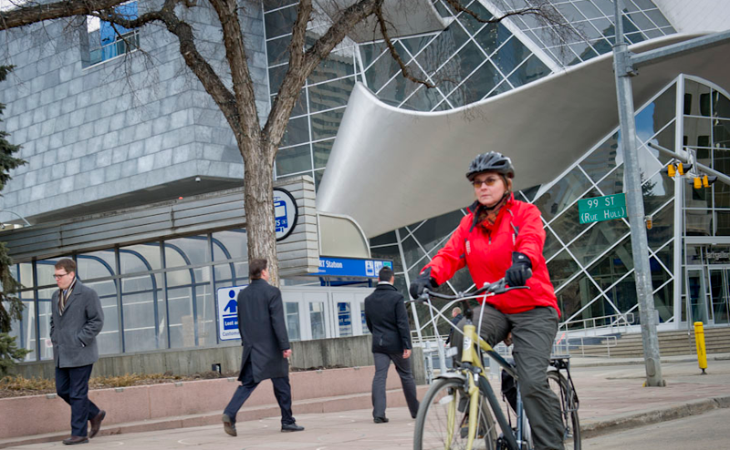 People cycling and walking downtown