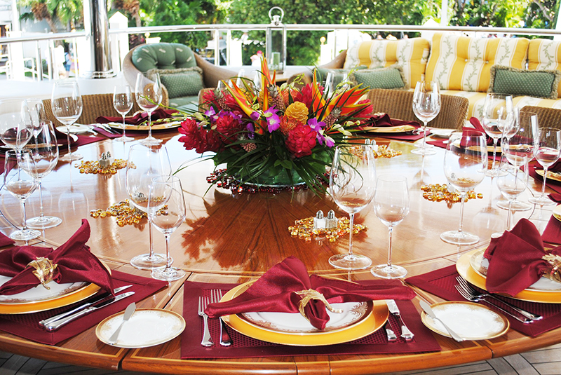 Expertly set table with full place settings and a large flower bouquet