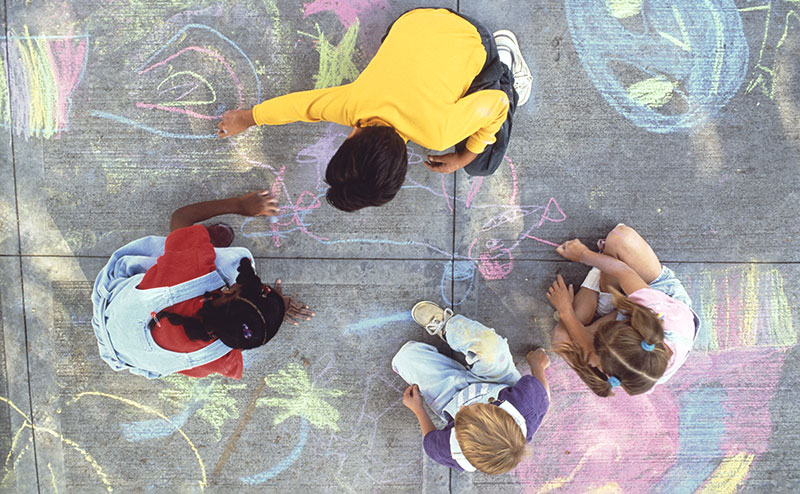 Children playing with sidewalk chalk