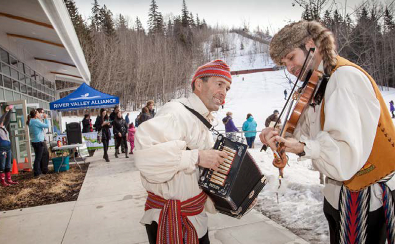 Accordion player and a man playing fiddle.