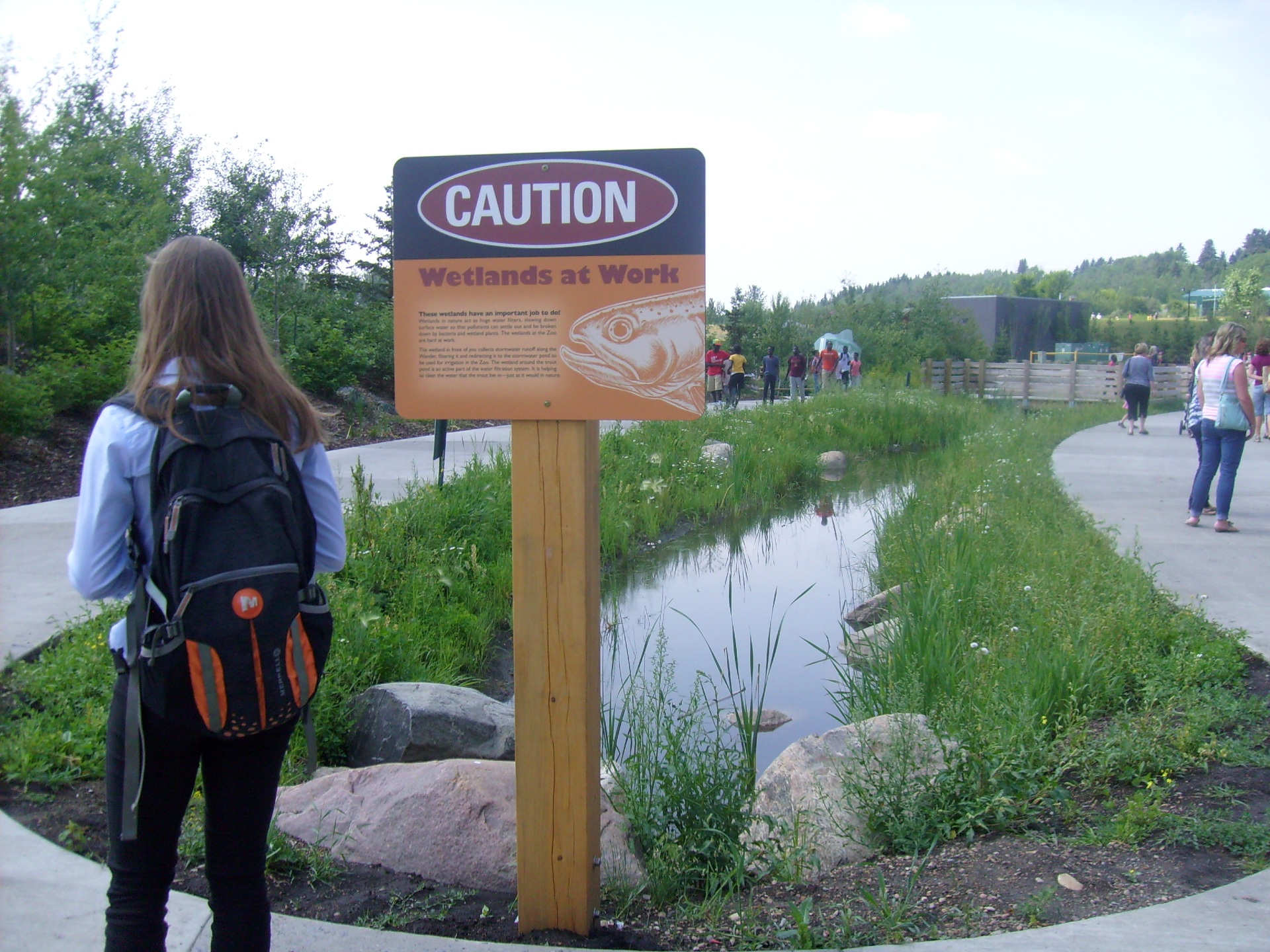 Photo of a visitor at the Valley Zoo in front of low impact landscaping.