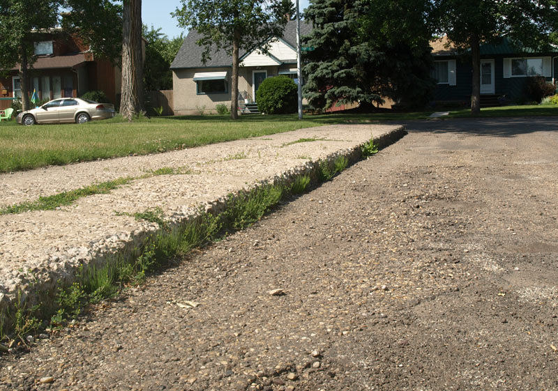 A closeup of a curb that needs to be replaced