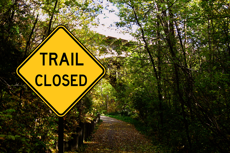 sign saying trail closed