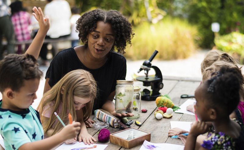 woman doing crafts with children