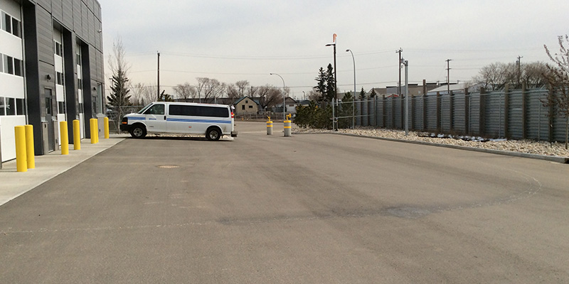 A graded lot in front of a commercial building