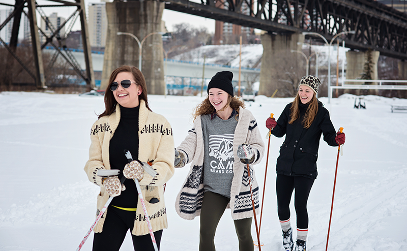 Three women cross-country skiing.