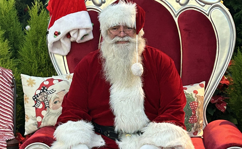 Santa Claus sitting in a large chair.