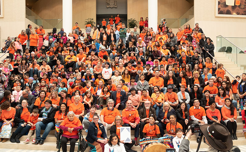 group of people in orange shirts