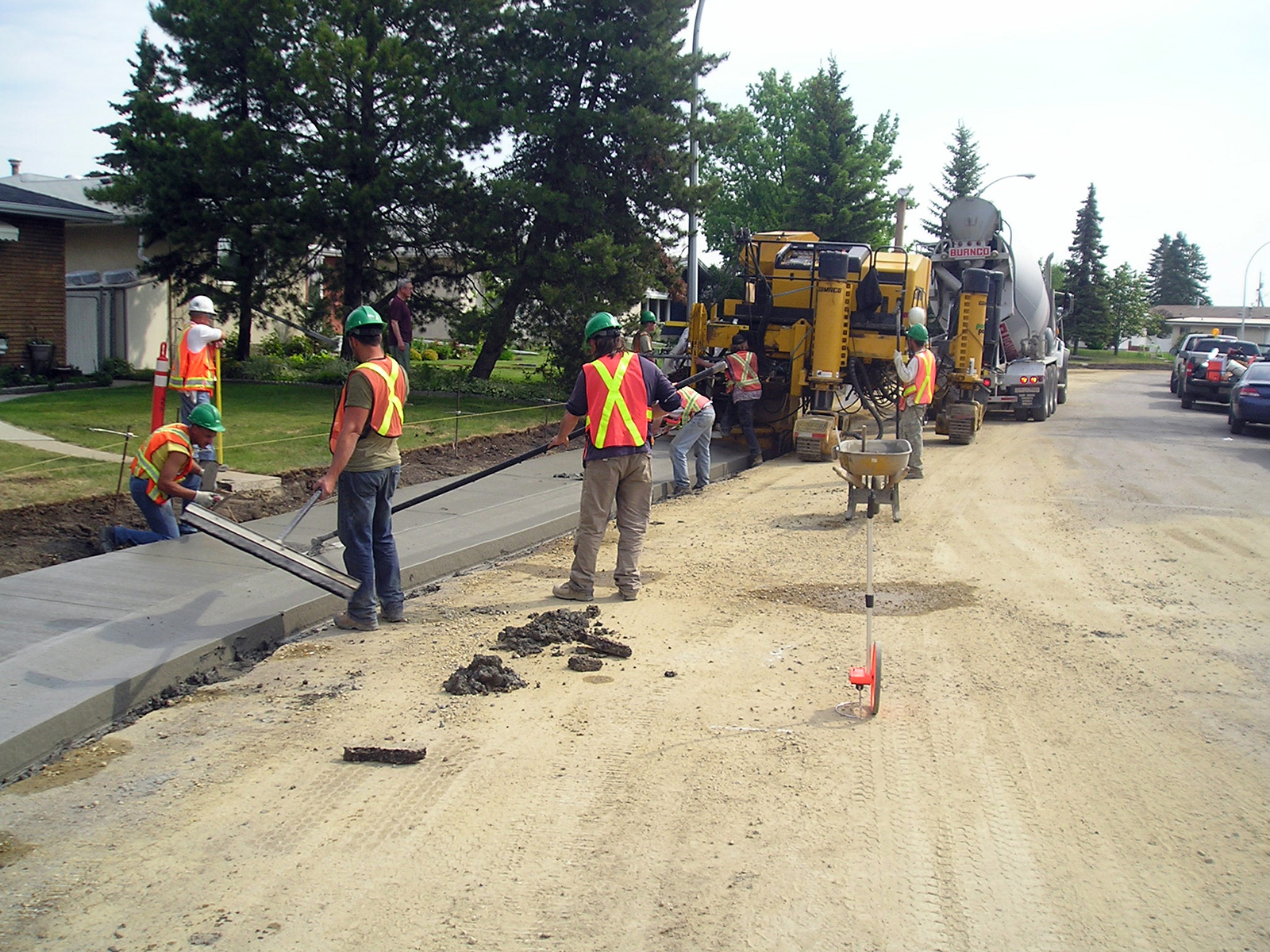 Workers reconstructing a sidewalk