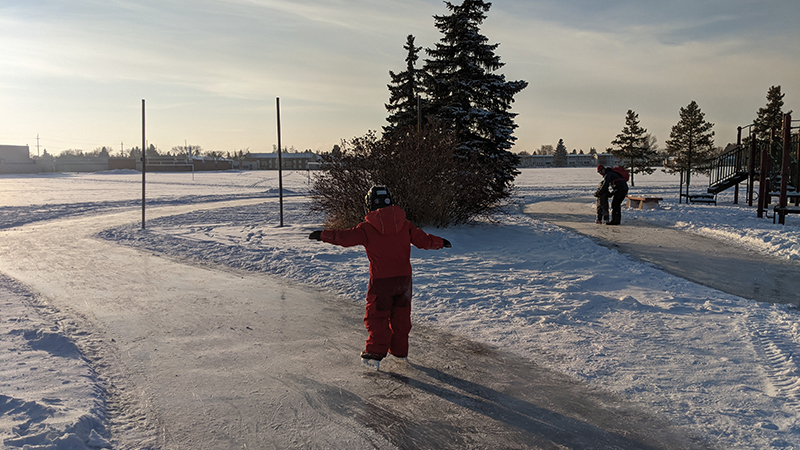 people skating in frozen playground