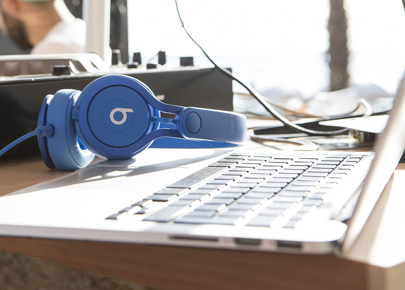 Close up of a set of headphones sitting on a laptop computer