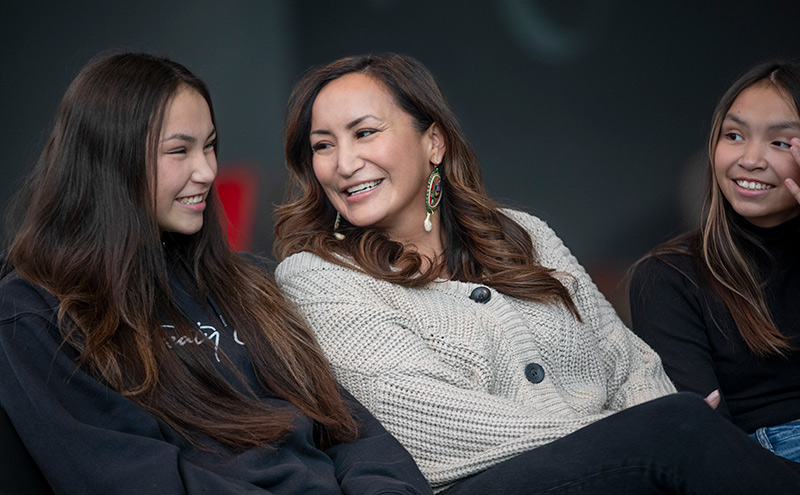 3 indigenous persons sitting at table