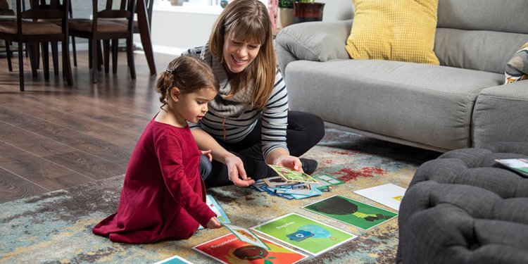 person with kid on rug with posters