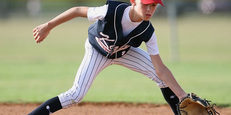 Young player catching a grounder ball