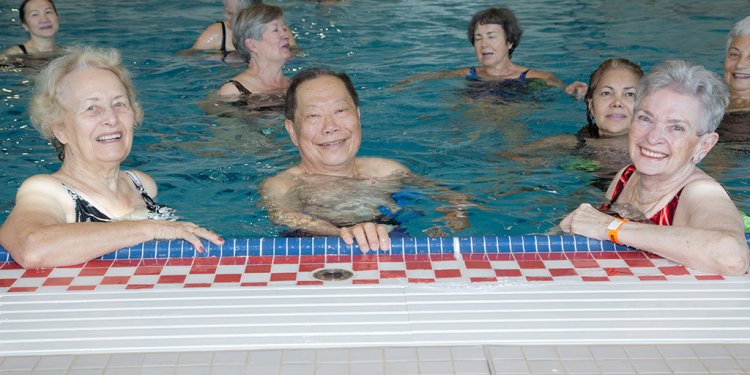 A group of older adults in a pool.