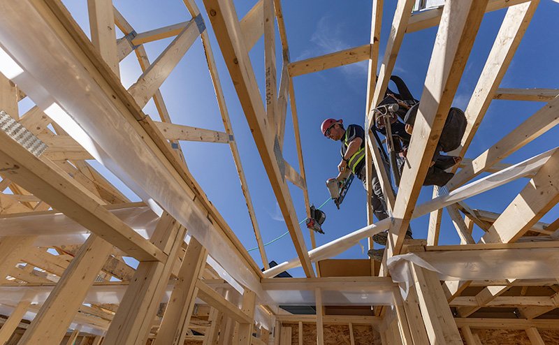 construction workers on house frame