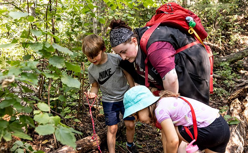 kids in forest with guide