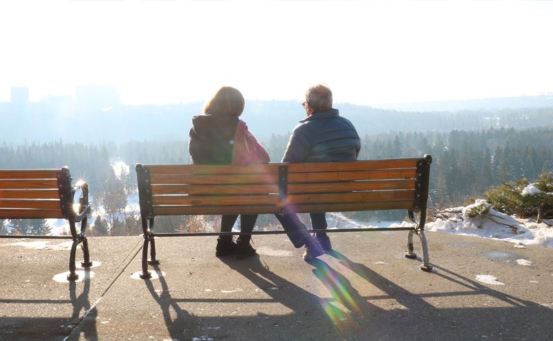 Two people on a bench.
