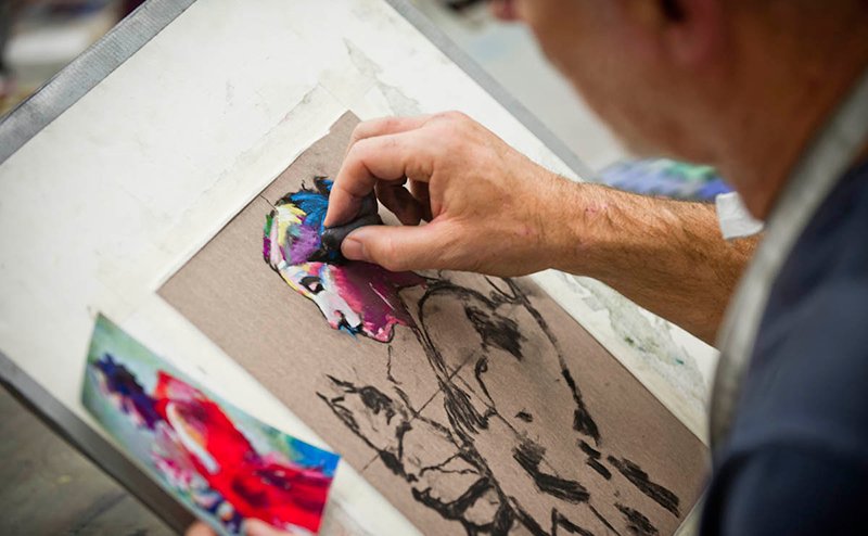 person painting the picture of an indigenous person