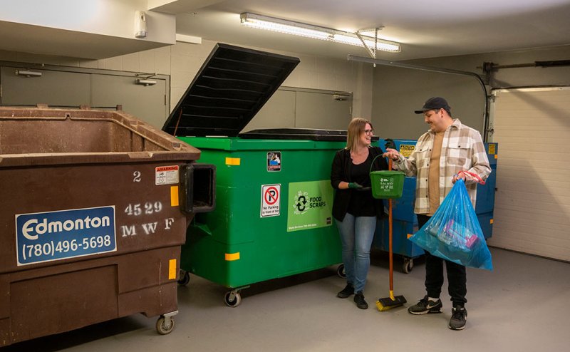people at communal garbage bins